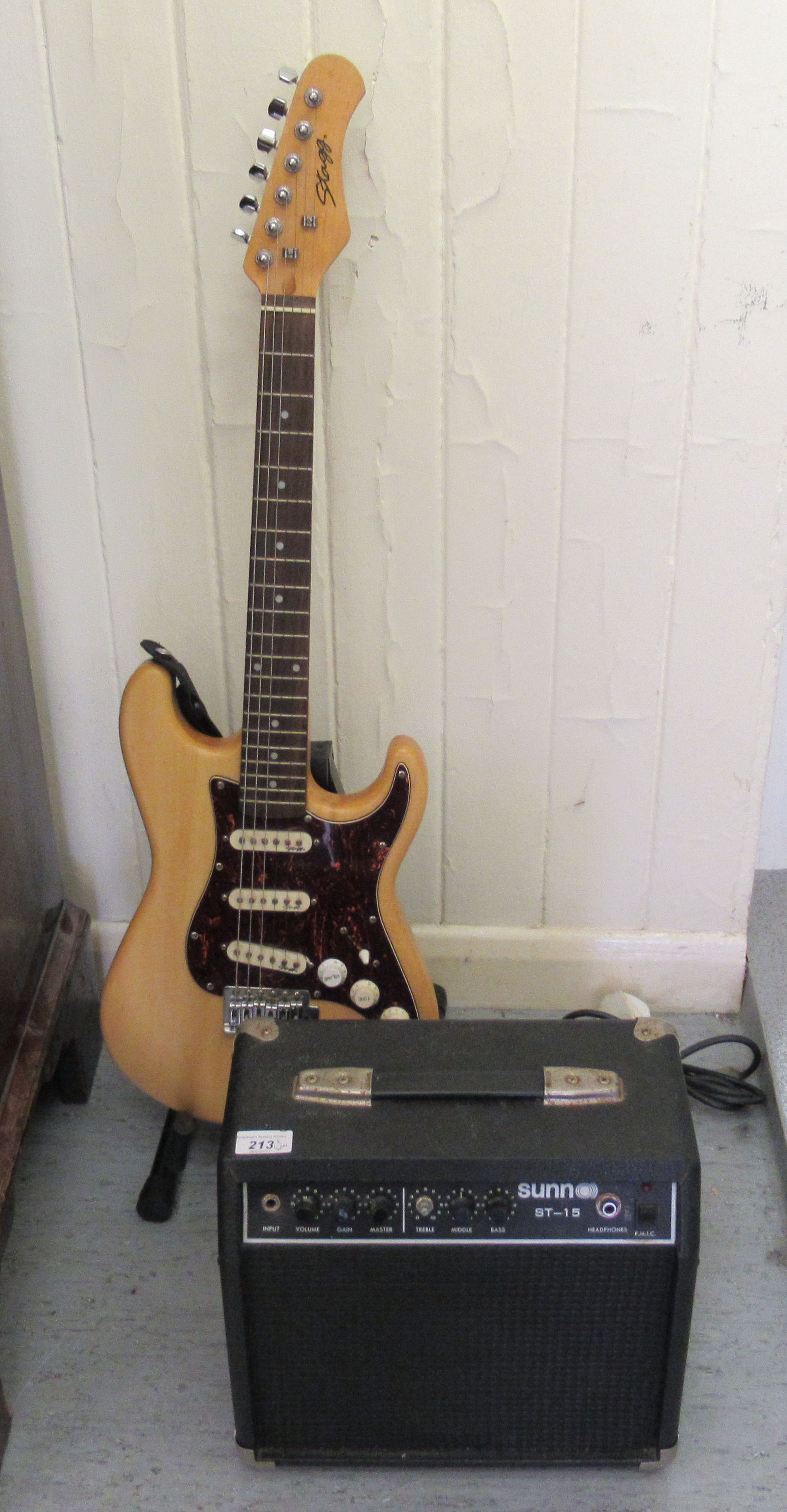 A Stagg electric guitar, on stand; and a Sunn ST-15 amp