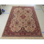 A Caucasian rug, decorated with floral and foliate designs, on a cream coloured ground  78" x 110"