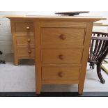 A pair of modern light oak three drawer bedside chests, raised on square, tapered feet  24"h  20"w