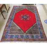 A Moroccan woollen rug, decorated in bright colours with floral designs  79" x 120"