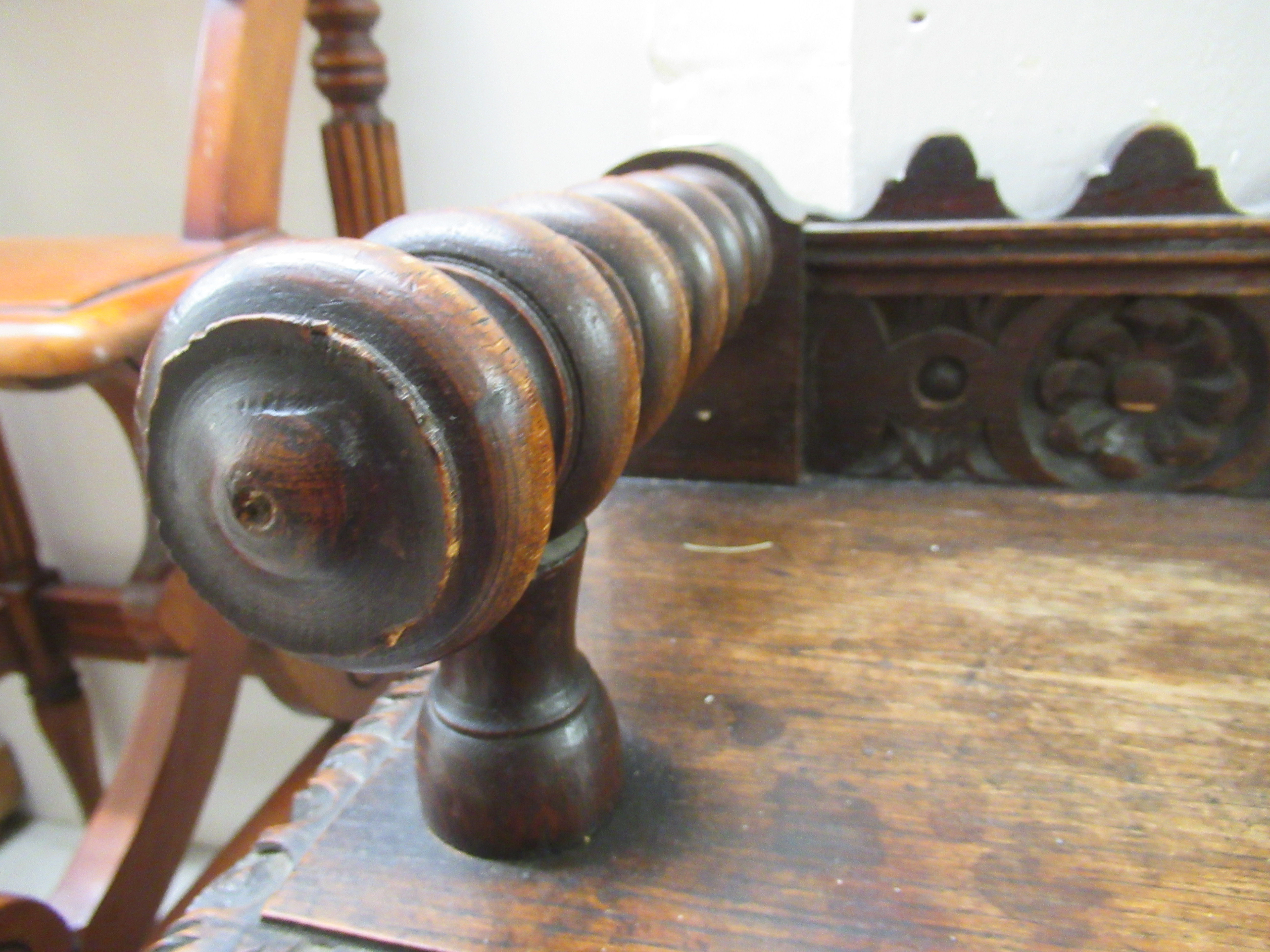 A late Victorian oak window seat with a carved gallery back and turned arms, raised on ring turned - Image 3 of 5