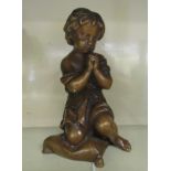 A mid 20thC cast bronze figure of a girl kneeling on a pillow praying (possibly, originally a