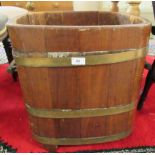 An early 20thC coopered fruitwood log bin with opposing riveted handles  19"sq