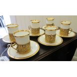 A set of six Halcyon Days porcelain coffee cans and saucers, highlighted with gilt banding and
