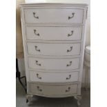 A 20thC cream coloured and gilt painted bowfront dressing chest with six graduated drawers, raised