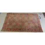 A Persian rug, profusely decorated with stylised designs, on a multi-coloured ground  50" x 85"