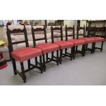 A set of six early 20thC Derbyshire inspired stained oak bar back dining chairs, the later fabric