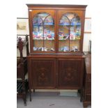 An Edwardian satinwood inlaid mahogany display cabinet with two astragal doors, over two panelled