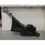 A Hayter Harrier 41 petrol driven lawn mower with a 15"dia rotary cut and grassbox