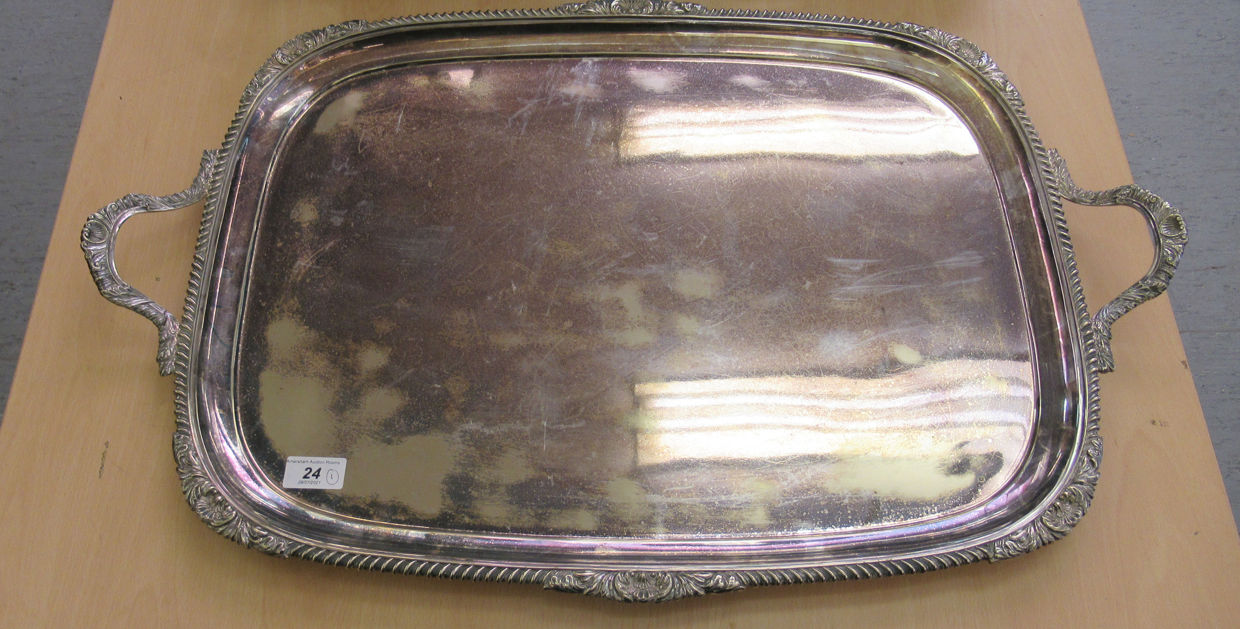 A Victorian style Goldsmiths & Silversmiths silver plated twin handled serving tray with a ribbed,