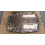 A Victorian style Goldsmiths & Silversmiths silver plated twin handled serving tray with a ribbed,