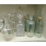 Coloured and clear glass kitchen bottles: to include three impressed Poison with ground stoppers