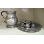 18th & 19thC pewter tableware: to include one large and five small mugs; and a plate  8.75"dia