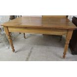 A late Victorian stained pine farmhouse kitchen table with an end drawer, raised on turned,