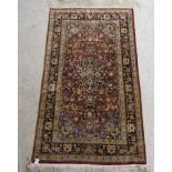 A mid 20thC Persian part silk rug with floral motifs, on a brown ground and tasselled ends  35" x