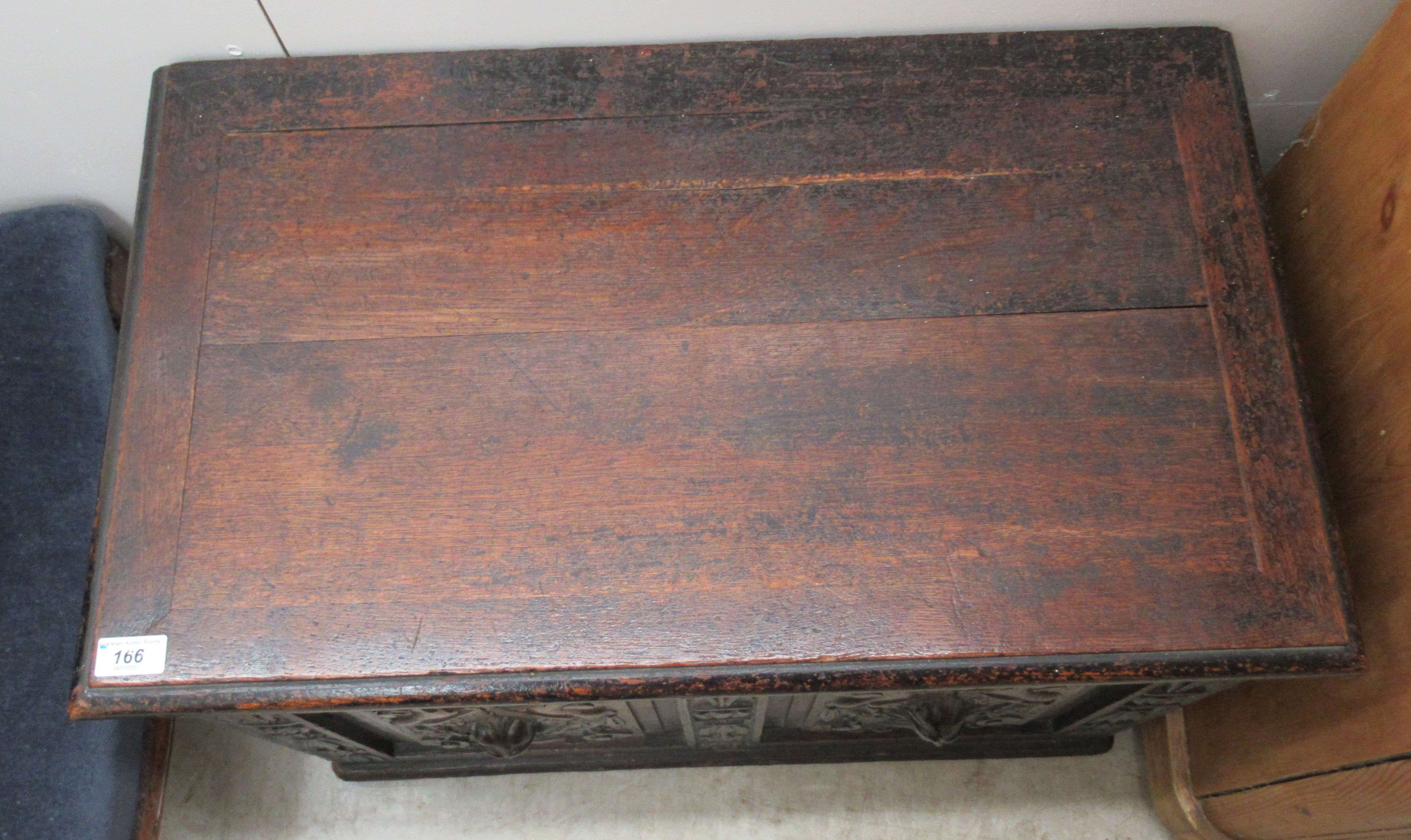 A late Victorian oak coffer with a hinged lid, over a twin panelled front and carved mask motifs, on - Image 2 of 3