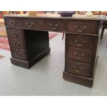 An early 20thC oak nine drawer, twin pedestal desk, on a plinth  29"h  48"w