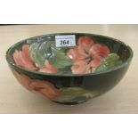 A Moorcroft pottery bowl, decorated with pink flora, on a green ground  6.5"dia