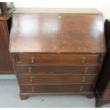 A 1930s oak bureau, the fall flap over four graduated drawers, raised on bracket feet  39.5"h  36"w