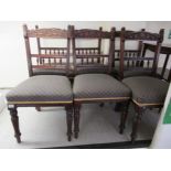 A set of six Edwardian mahogany framed dining chairs, each with a foliate carved crest and a
