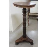 A William VI rosewood wine table, raised on a ring turned, tapered column and triform base  27"h