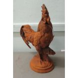 A modern rust coloured cast iron terrace ornament,  a standing cockerel, on a plinth  17"h