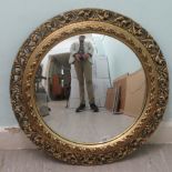 A modern convex mirror, set in an antique finished moulded gilt frame  25"dia overall