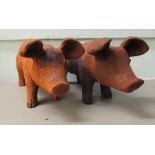 A pair of rust finished cast iron model pigs  7"h  17"L