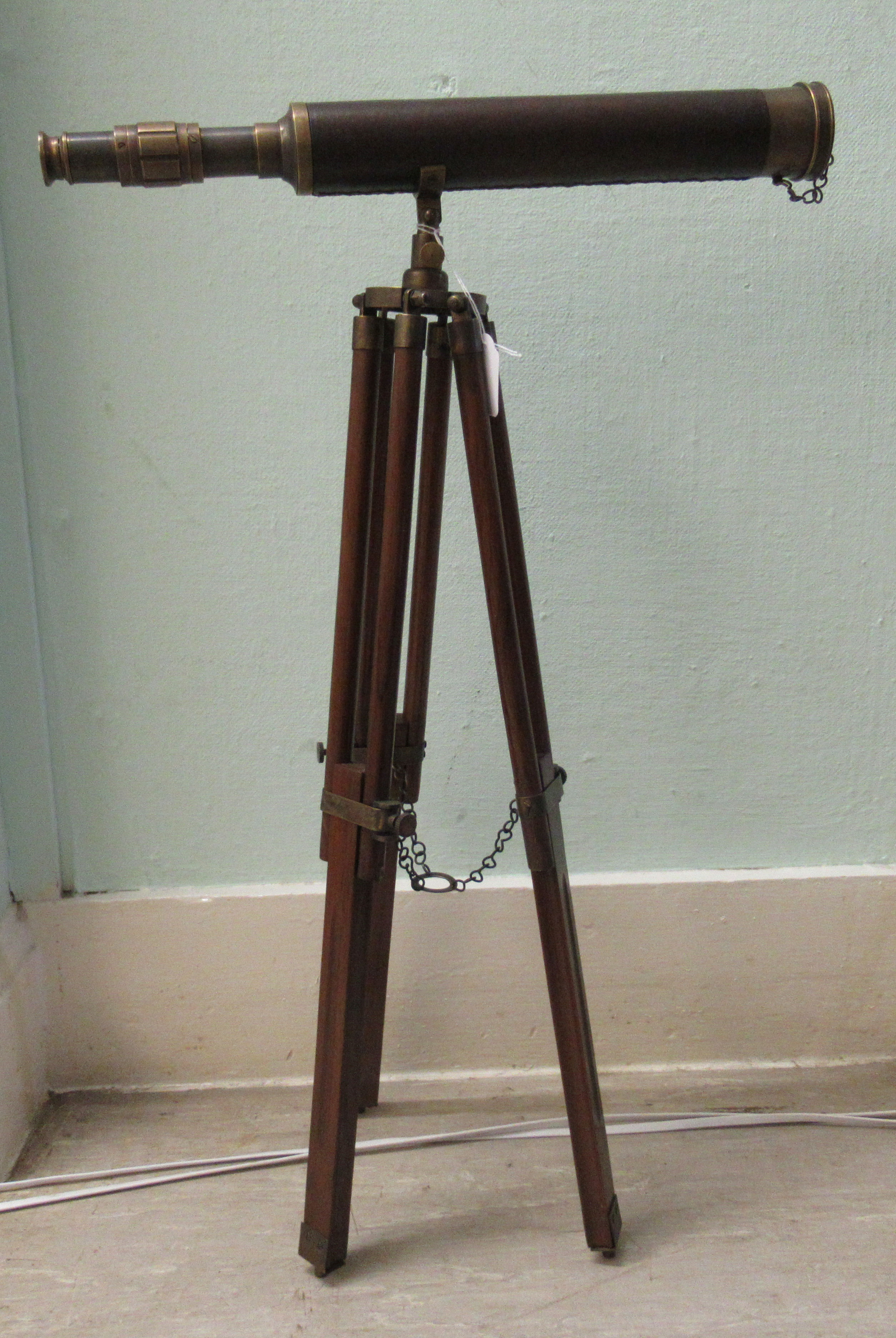 A modern reproduction of a 19thC brass telescope, on a tripod stand  26"h