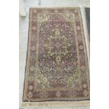 A Persian rug, decorated with stylised designs, on a multi-coloured ground  64" x 36"