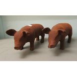 A pair of rust coloured cast iron model pigs  5"h  12"L