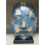 A South American made pavo shell and lapis coloured stone ornamental mask, on a plinth  7.5"h