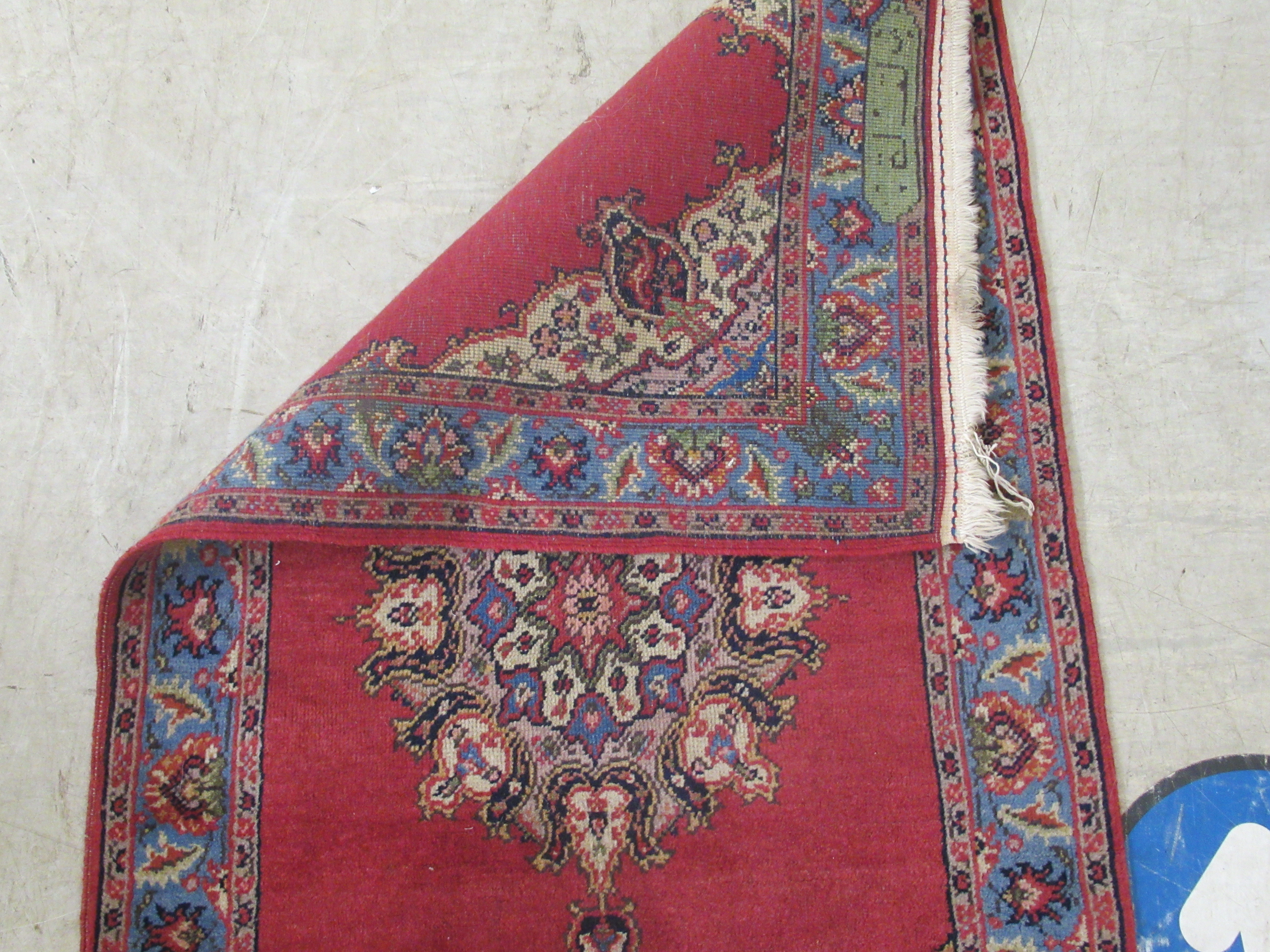 A Tabriz rug, decorated with a central medallion, bordered by floral designs, on a red ground - Image 5 of 5