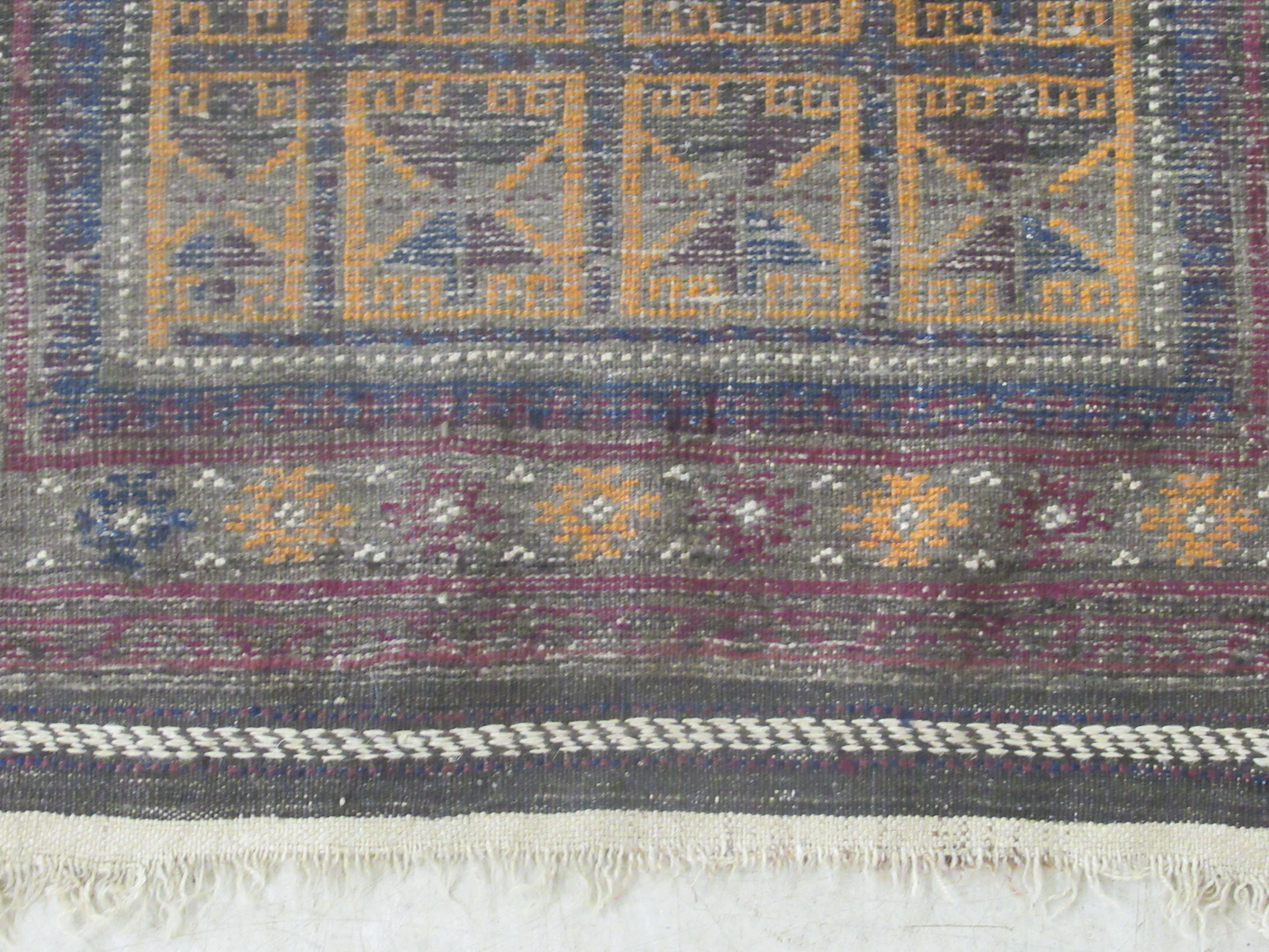 A Baluchistan rug, decorated with repeating stylised designs, on a brown ground  35'' x 42'' - Image 3 of 6