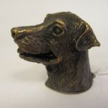 A cast brass novelty dog's head vesta case with a strikeplate on the hinged cap