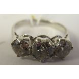 An 18thC white gold claw set, three stone diamond ring