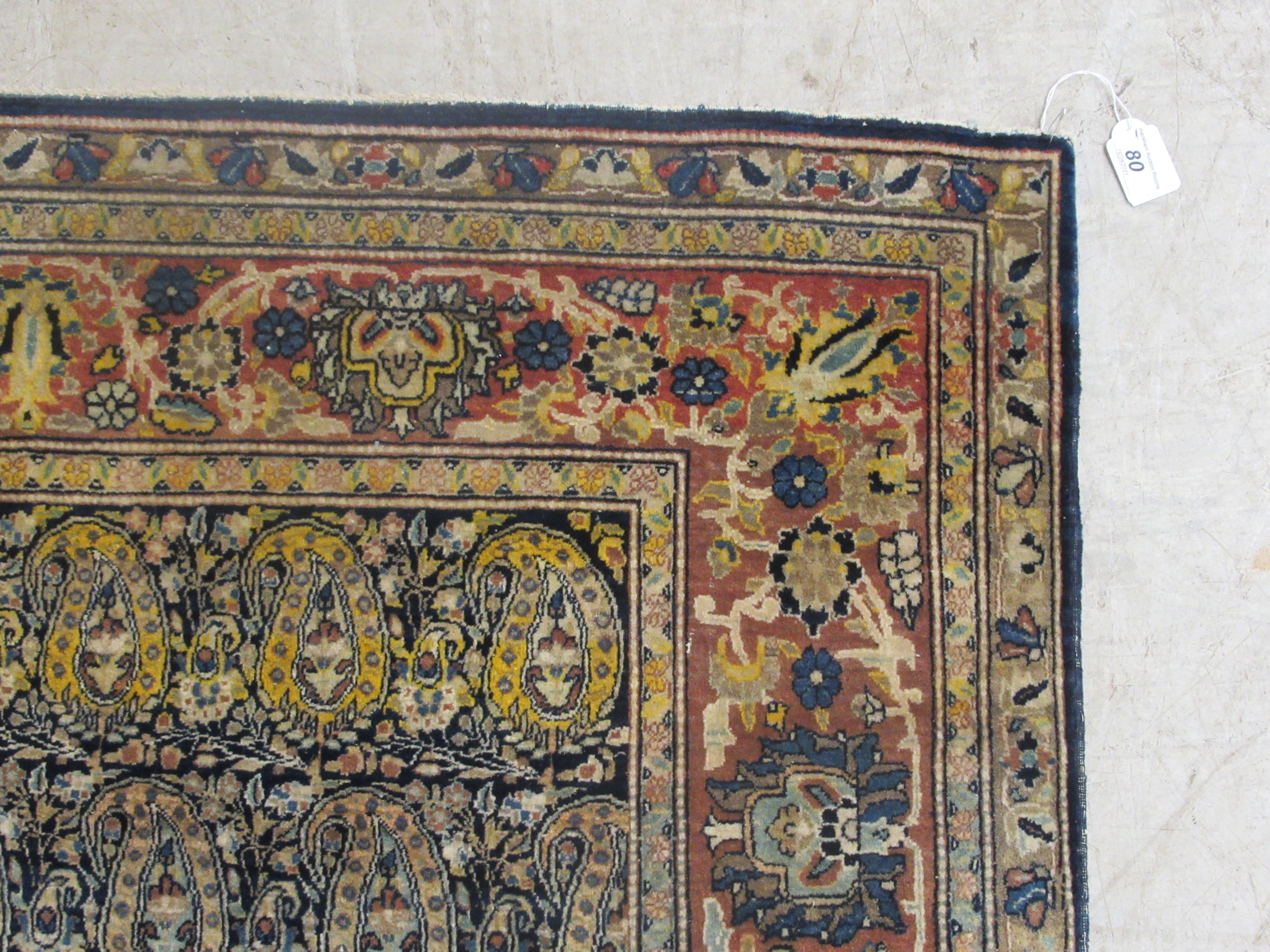 A Persian rug, decorated with repeating stylised designs, bordered by flora and foliage, on a - Image 4 of 5