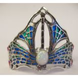 A silver pliqué-a-jour butterfly design, hinged bangle, set with an opal and rubies