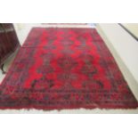 A Persian carpet, decorated with stylised designs, on a red ground  140'' x 110''