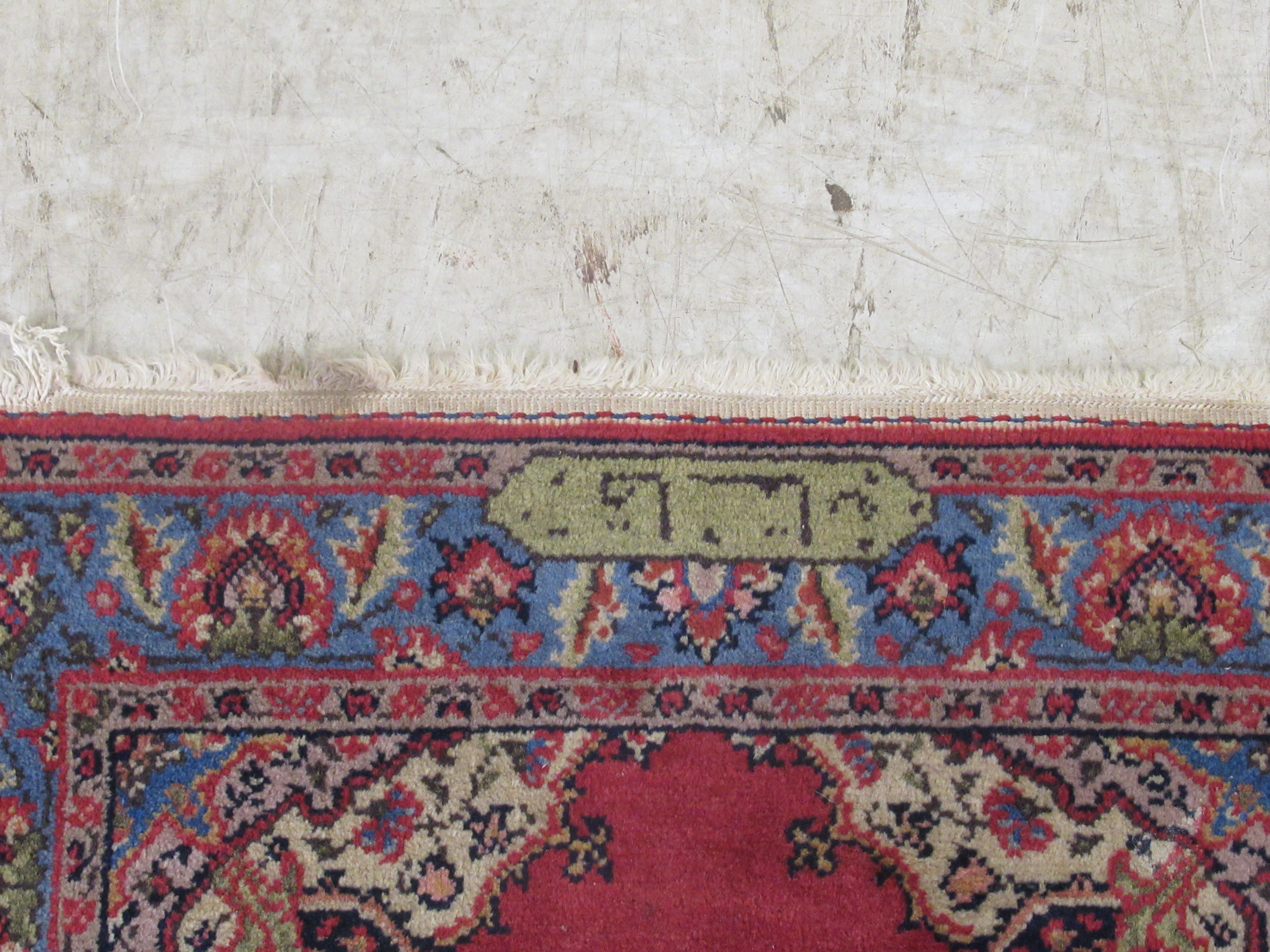 A Tabriz rug, decorated with a central medallion, bordered by floral designs, on a red ground - Image 4 of 5