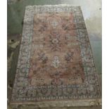 A Tabriz rug, decorated with symmetrical flora and foliate designs, on a pink ground  55" x 90"