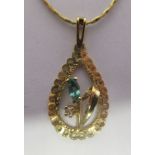 A 9ct gold and emerald set teardrop pendant, on a fine neckchain