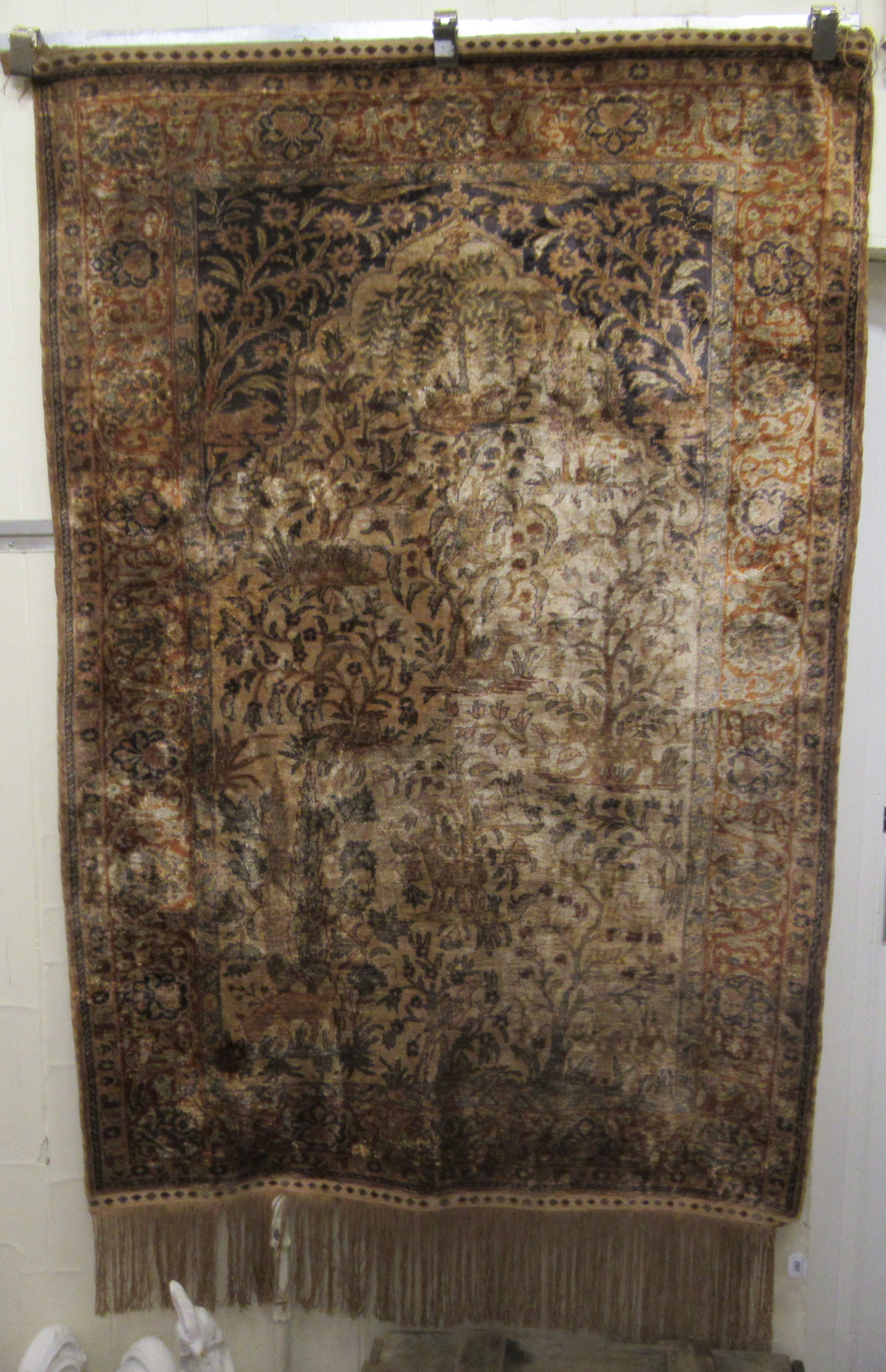 A Persian, partial silk, woven pictorial rug, decorated with animals, trees and other stylised