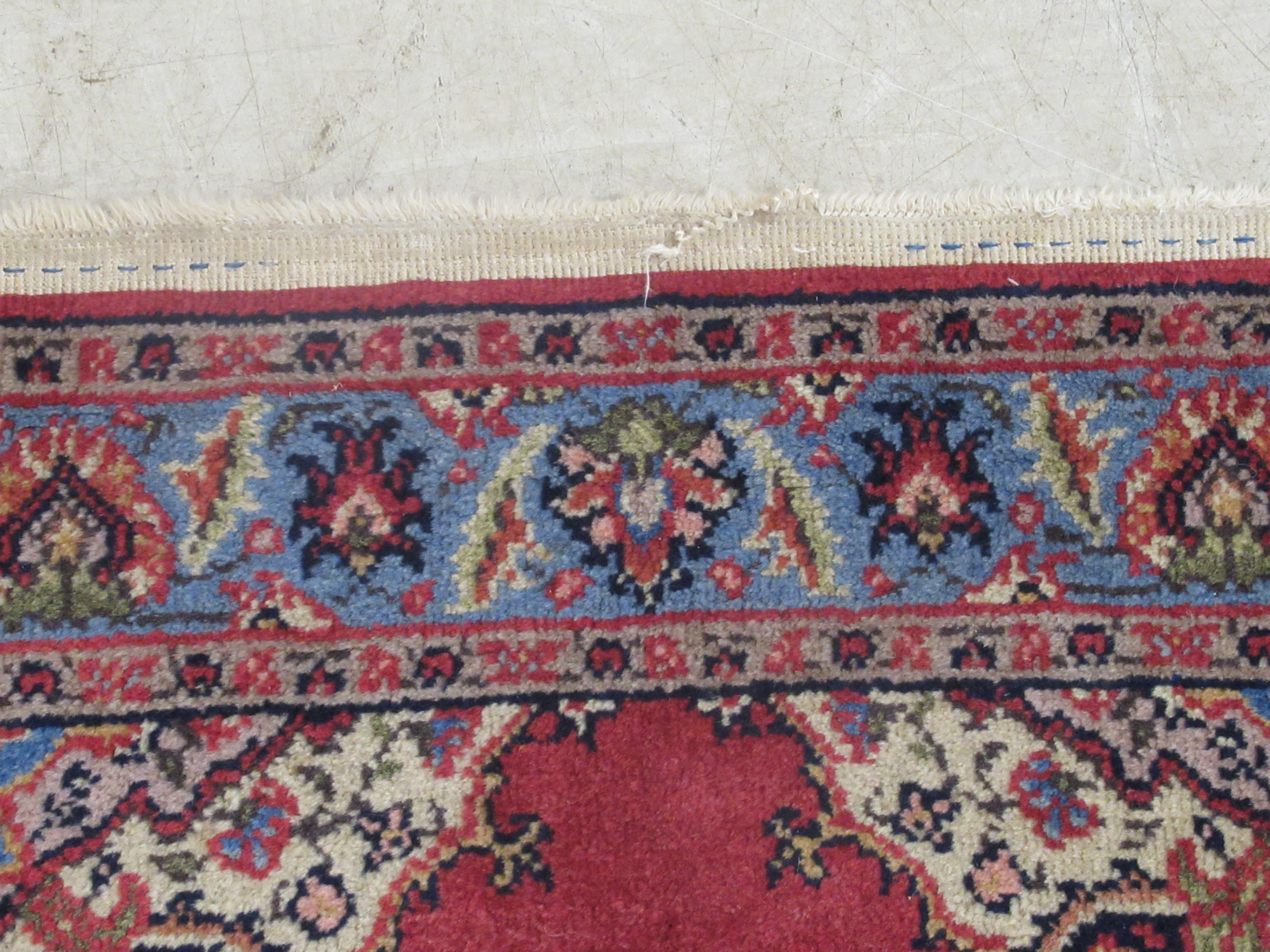 A Tabriz rug, decorated with a central medallion, bordered by floral designs, on a red ground - Image 3 of 5