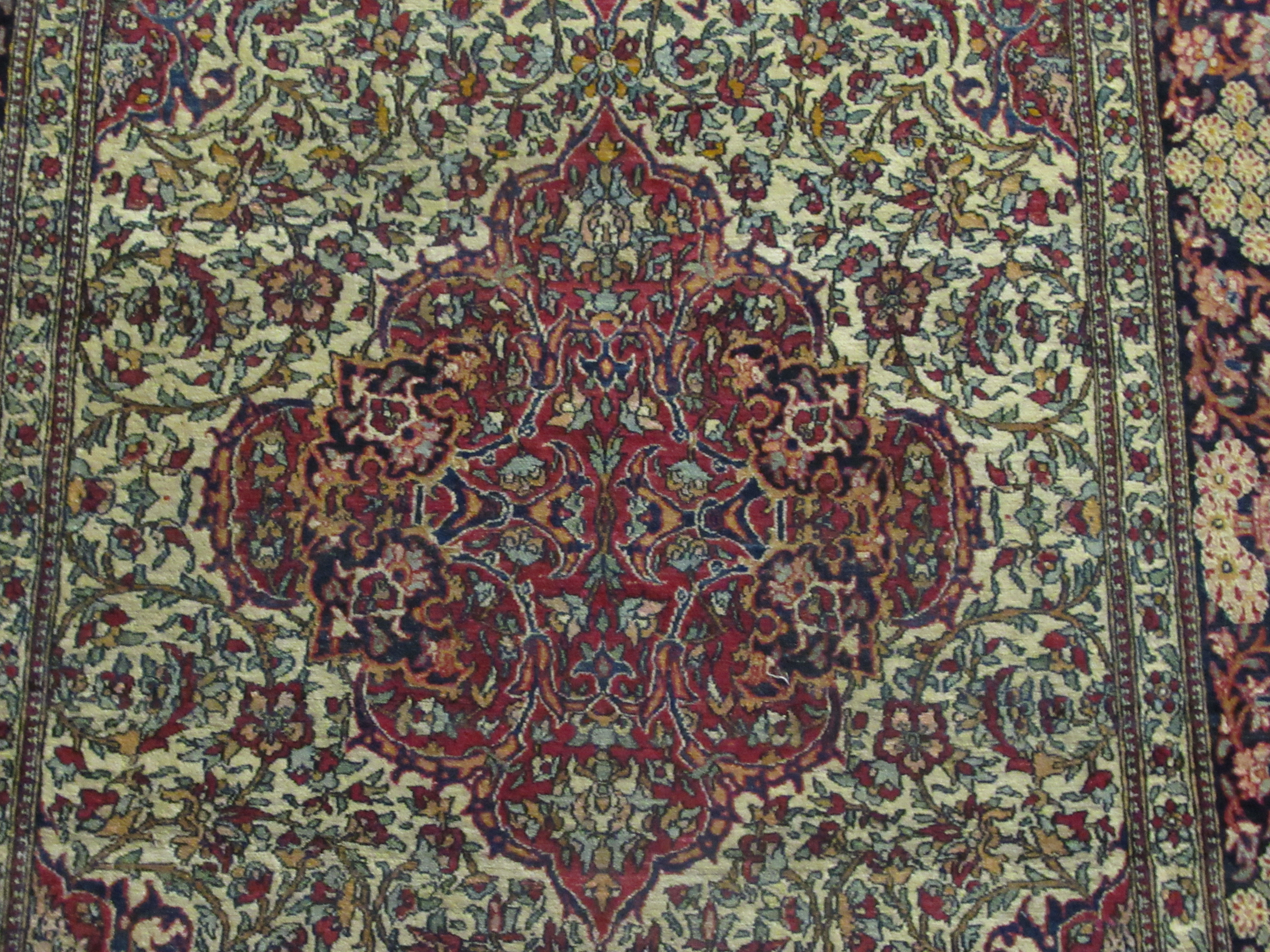 A Persian rug, decorated with a serpentine outlined medallion, bordered by stylised designs on a - Image 2 of 5