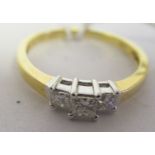 An 18ct gold claw set three stone diamond ring