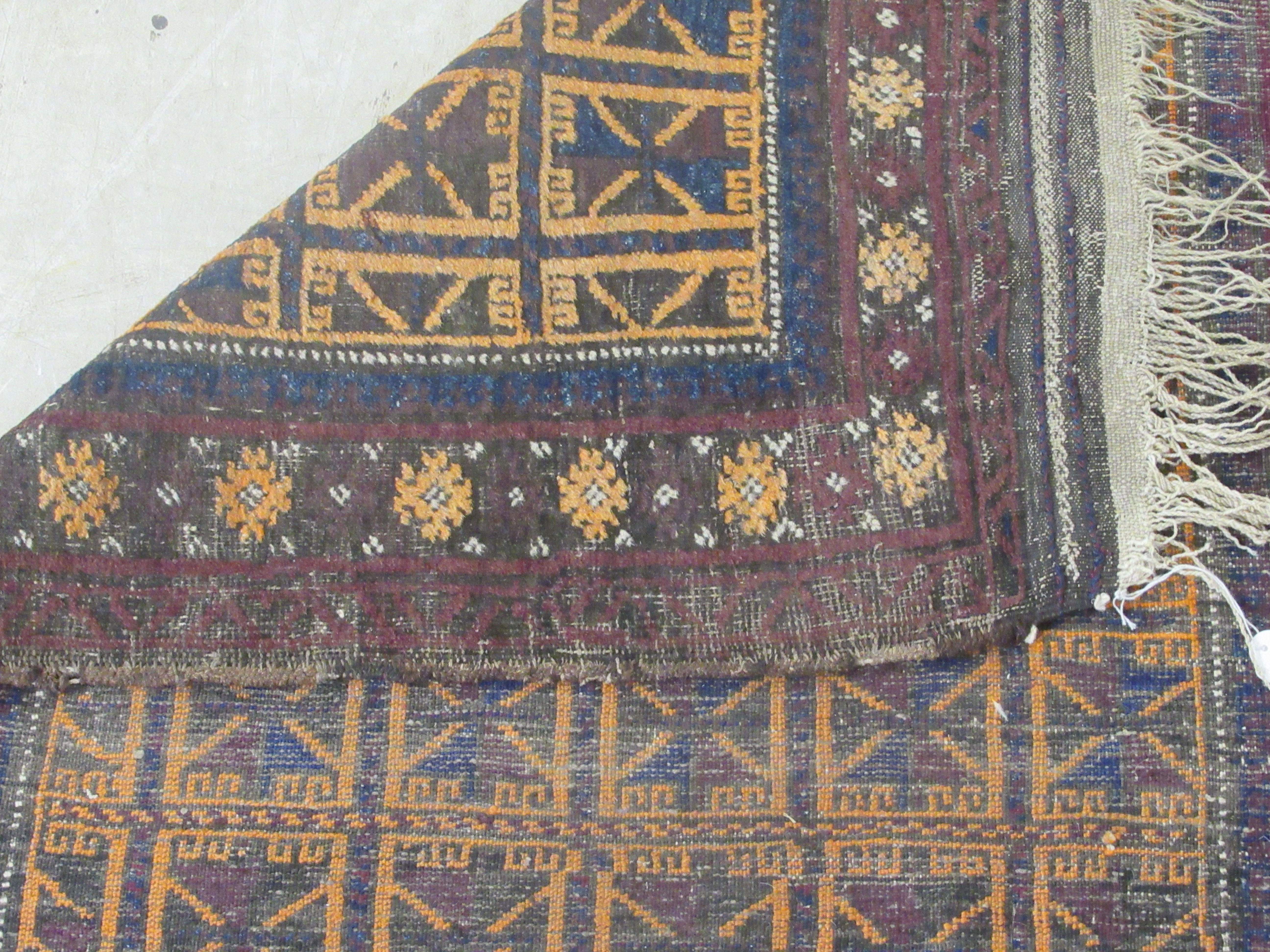 A Baluchistan rug, decorated with repeating stylised designs, on a brown ground  35'' x 42'' - Image 6 of 6