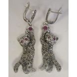 A pair of silver and marcasite panther earrings, set with rubies