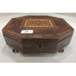 A 19thC rosewood games box of elongated, octagonal form, decorated on the lid with a geometrically
