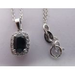 An 18ct white gold sapphire and diamond set pendant, on a fine neckchain